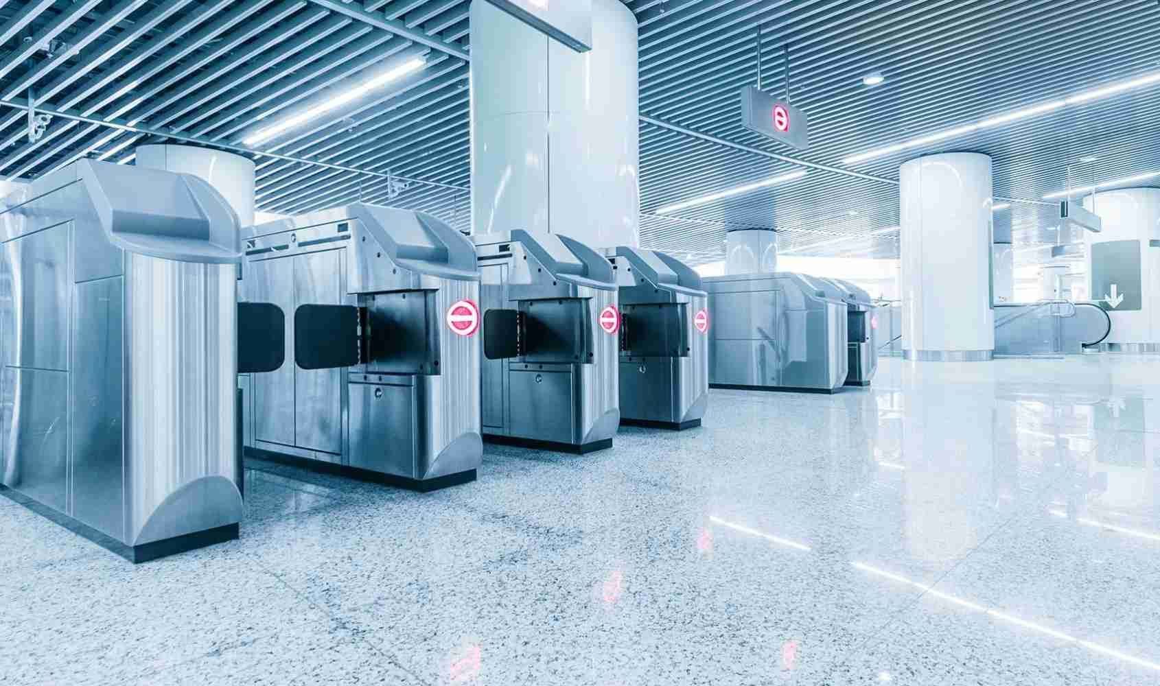 Row of flap barriers at a busy entrance